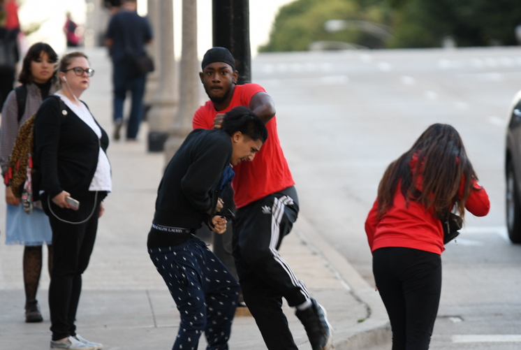 Two young men fighting on the corner of Jackson Street and Michigan Ave in Chicago