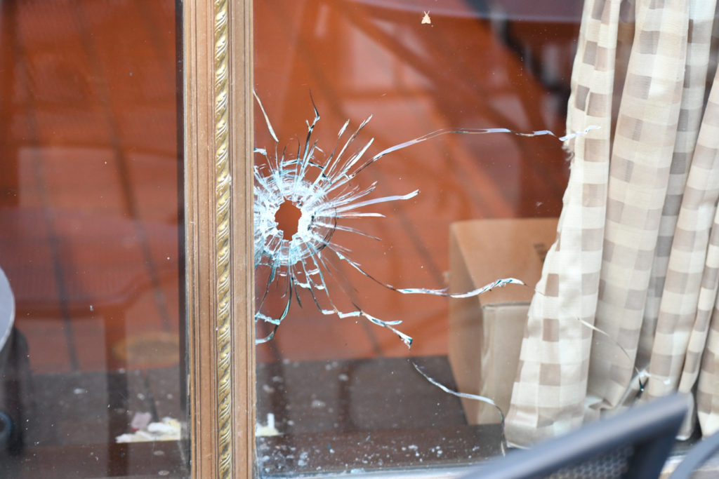 Bullet hole in the glass window of the Corner Bakery, on the corner of Michigan Ave and Jackson St. 